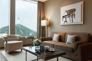 a living room with a couch and a table at Courtyard by Marriott Seoul Namdaemun in Seoul