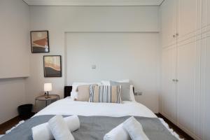 a bedroom with a large white bed with two pillows at Seaside 2 Bedrooms Apartment in Glyfada in Athens