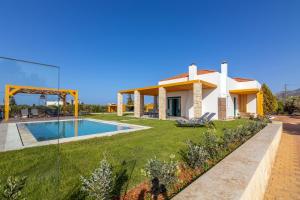 a villa with a swimming pool and a building at Villa Sandi with Private Pool in Hersonissos +42 photos