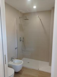 a bathroom with a shower and a toilet and a sink at Le Conchiglie Residence in Porto Torres