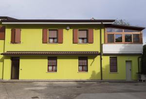 a yellow house with windows on a street at Casa Salera in Lonato