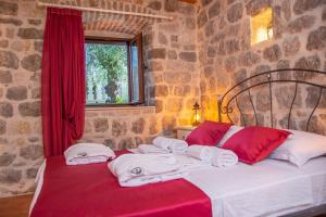a bedroom with a bed with towels on it at Pallazo Uniqato seafront in Kotor