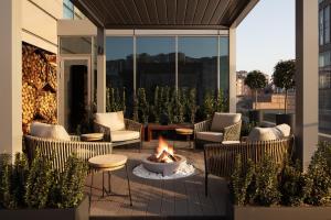 a patio with chairs and a fire pit on a balcony at Four Points by Sheraton Istanbul Kagithane in Istanbul