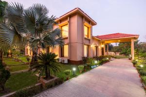 a house with a pathway in front of it at ama Stays & Trails 25 Farm House, Vedic Village, Kolkata in Kolkata