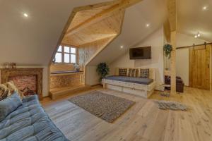 a living room with a couch and a fireplace at Chalet Zur Wildrose in Freyung