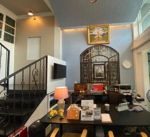 a living room with a table with a lamp at Jeboutiquelangsuan hotel in Lang Suan