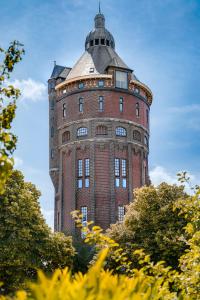 a tall brick building with a dome on top of it at Hotel Watertoren West in Groningen