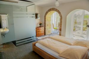 a bedroom with a large bed and a sink at Plantagengut Hosterwitz in Dresden
