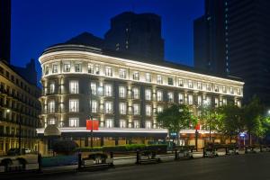 a large building with lights on in a city at night at OPARTMENT（远东饭店） in Shanghai