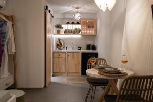 a small kitchen with a table and a dining room at CABO ESTE SUITES in Akrotiri