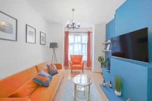 a living room with a couch and a flat screen tv at The Marsden - Modern 3 bed, Virgin TV, WIFI in Edmonton