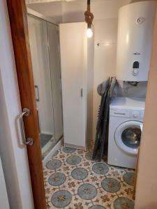 a bathroom with a toilet and a washing machine at LA CASA AZUL in Chelva +12 photos