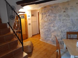 a staircase in a room with a stone wall at LA CASA AZUL in Chelva