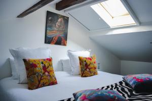 a attic bedroom with two beds and a window at Le Manoir Hotel, BW Signature Collection in La Rochelle