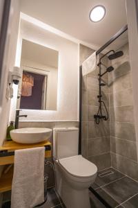 a bathroom with a toilet and a sink and a mirror at Ivy Ayvalık Butik Otel in Ayvalık +60 photos