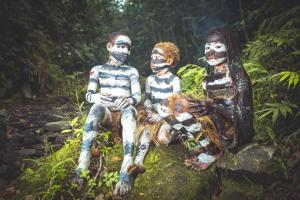a group oficans with painted faces sitting on a rock at Omo Bugamo Skeleton Tribe Eco Resort in Genetisarobe +38 photos