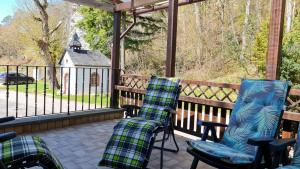 a porch with chairs and a view of a church at Ferienwohnungen Nohner Mühle in Nohn +3 photos
