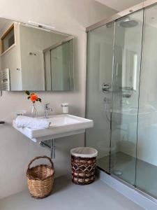a bathroom with a sink and a glass shower at Agriturismo B&B TorreBianca in Manduria