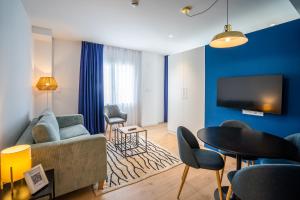 a living room with a couch and a table at abba Apartments Playa de Gros San Sebastián in San Sebastián