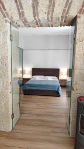 a bedroom with a bed in a brick wall at The City Walk in Naples
