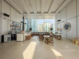 a large room with a view of a city at BRAND-NEW 1 Bedroom with full Marina View in Dubai
