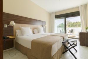 A bed or beds in a room at Hotel Finca Los Abetos