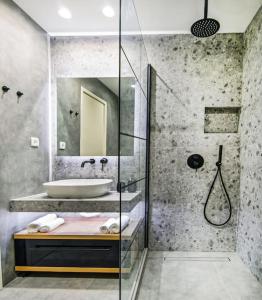 a bathroom with a sink and a shower at Menta Loft in Heraklio