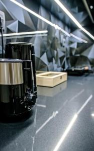 a black coffee cup sitting on a counter top at Menta Loft in Heraklio