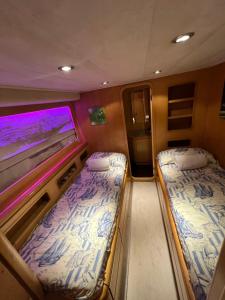 a train room with two beds and a window at Riti Yacht in Kalkara