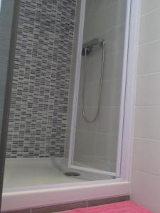 a shower with a glass door in a bathroom at Les Gites de Kerdurod in Guidel