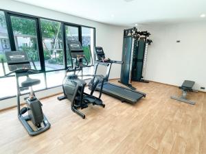 a gym with treadmills and elliptical machines at The Title V Condos by Gregory in Rawai Beach