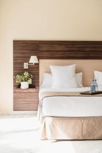a bedroom with a large bed with a wooden headboard at DWO Finca Los Abetos in Córdoba +29 photos