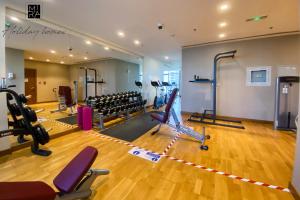 a gym with treadmills and chairs in a room at Mira Holiday Homes - Spacious Studio with Balcony - Free Wifi in Dubai