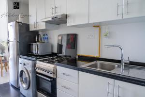 a kitchen with a sink and a stove top oven at Mira Holiday Homes - Spacious Studio with Balcony - Free Wifi in Dubai