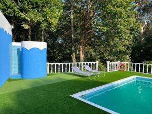 a yard with a pool and chairs and a fence at QUINTA DONA MANUELA in Formariz