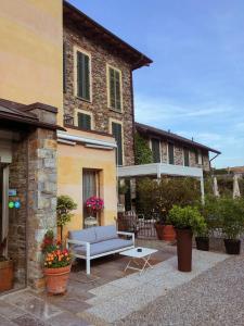 a patio in front of a building with a bench at Hotel Antica Stallera in Cannobio