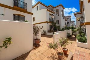 a courtyard of a house with potted plants at Precioso apartamento junto a Starlite Marbella by Rent Me in Marbella