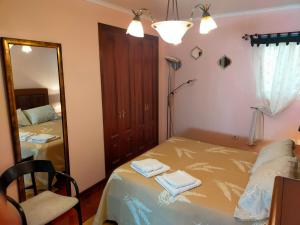 a bedroom with a bed with two towels on it at Piso Corunna Easy Parking wifi in Arteixo