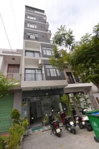 a building with motorcycles parked in front of it at POOLseaview - 1A Blue Sea Apart in Da Nang