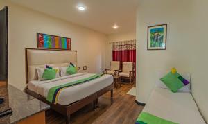 a bedroom with a bed and a desk and a chair at Treebo Kodai Kings Park, 650 M From Kodai Lake in Kodaikānāl +37 photos