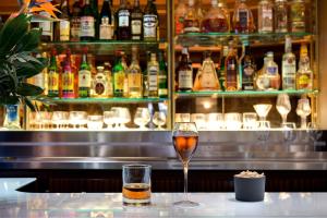 a glass of wine sitting on a counter in a bar at Splendid Etoile in Paris