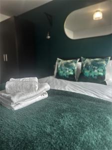 a hotel room with a bed with towels on it at Harbourside Hideaway - Superb Flat with Terrace in Bristol