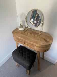 a wooden table with a mirror on top of it at Harbourside Hideaway - Superb Flat with Terrace in Bristol