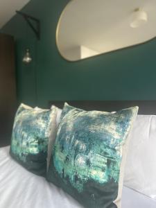 two pillows sitting on top of a bed at Harbourside Hideaway - Superb Flat with Terrace in Bristol