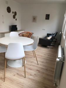 a living room with a table and chairs and a couch at Vivienda de uso turístico Rio Lor 1 in Lugo