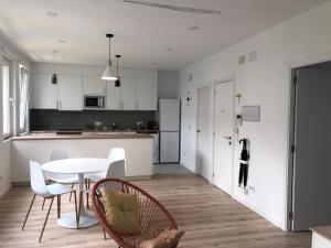 a kitchen and dining room with a table and chairs at Vivienda de uso turístico Rio Lor 1 in Lugo