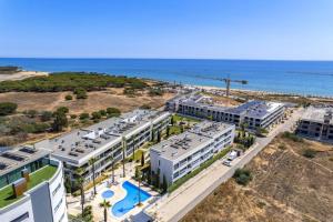 an aerial view of a resort near the ocean at Seaview Serenity with Pool & Garden in Quarteira