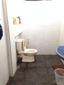 a bathroom with a white toilet in a room at Vegan Stay by The Vegan Kitchen by Sulo in Boralesgamuwa