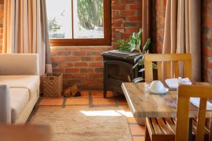 a living room with a couch and a table at Lovane Boutique Wine Estate and Guesthouse in Stellenbosch