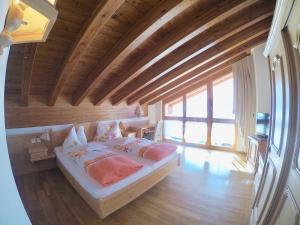 a bedroom with a bed in a room with wooden ceilings at Haus Adora in Leukerbad